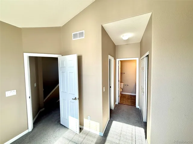 a view of a hallway with an entryway and closet