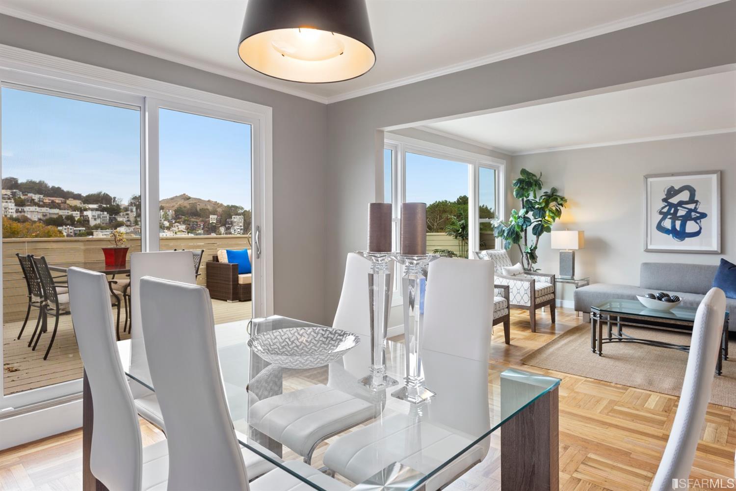 a dining room with furniture a large window and a rug
