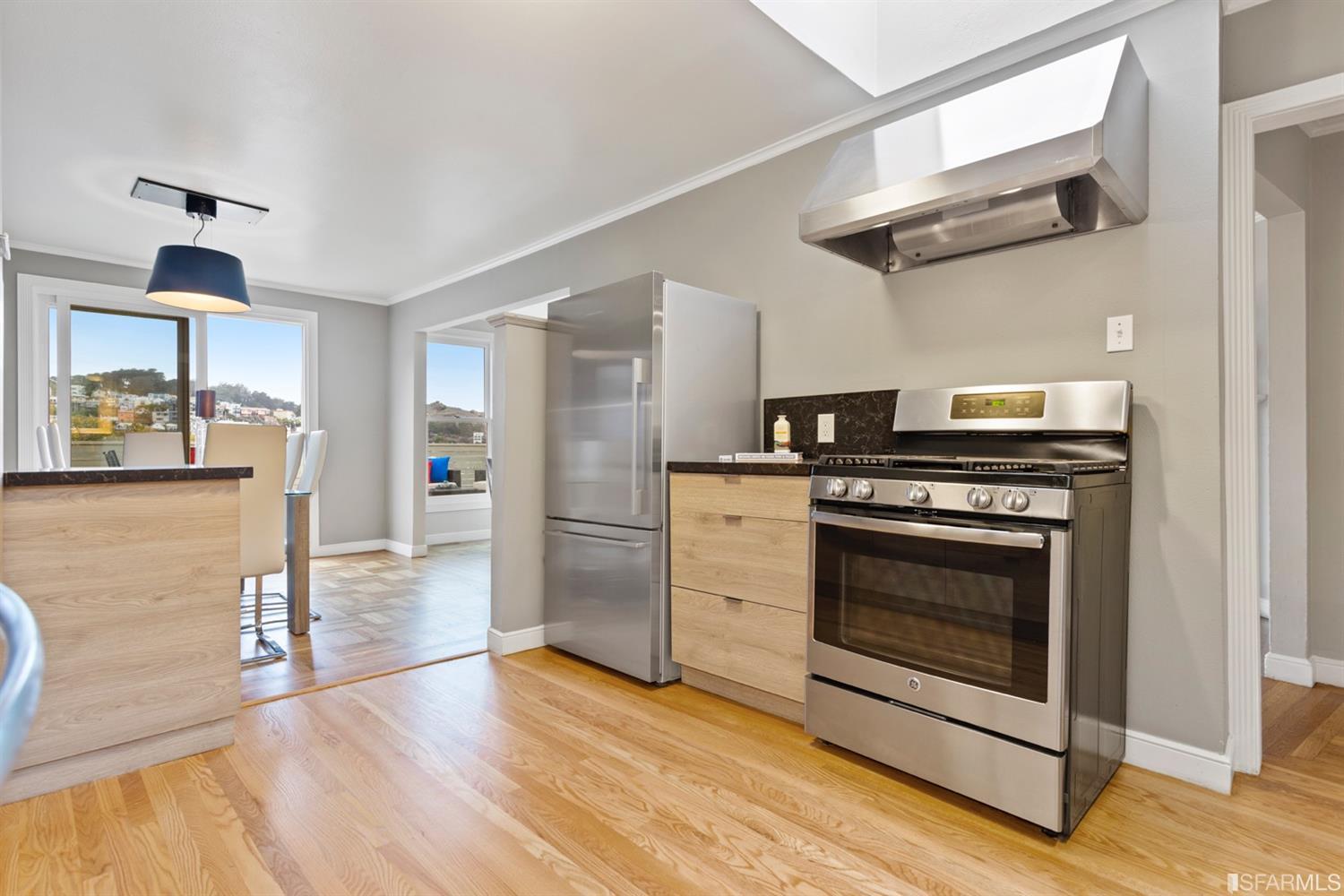 26 Eagle Street San Francisco, CA 94114 - Photo 12 of 56 a kitchen with stainless steel appliances granite countertop a stove a refrigerator and a wooden floors