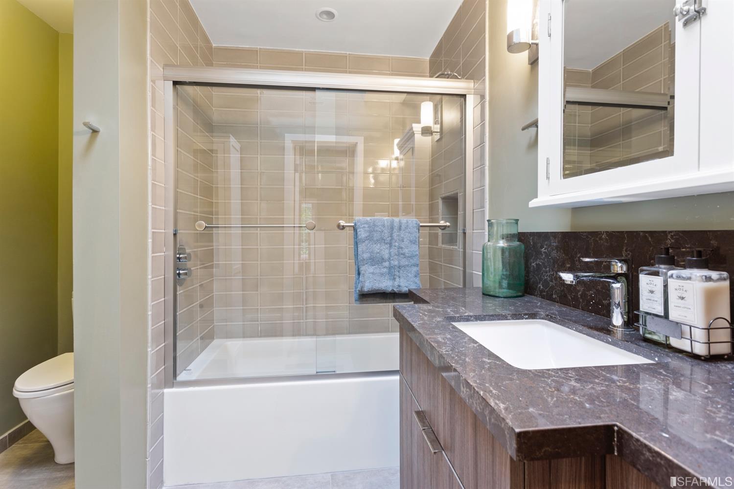 26 Eagle Street San Francisco, CA 94114 - Photo 26 of 56 a bathroom with a granite countertop sink a toilet and bathtub