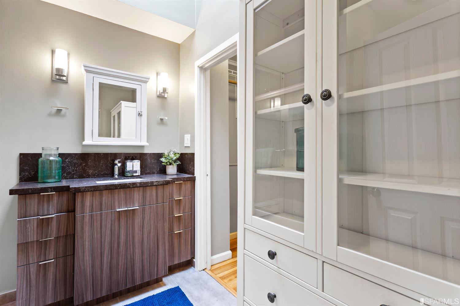 26 Eagle Street San Francisco, CA 94114 - Photo 27 of 56 a bathroom with a shower sink and mirror