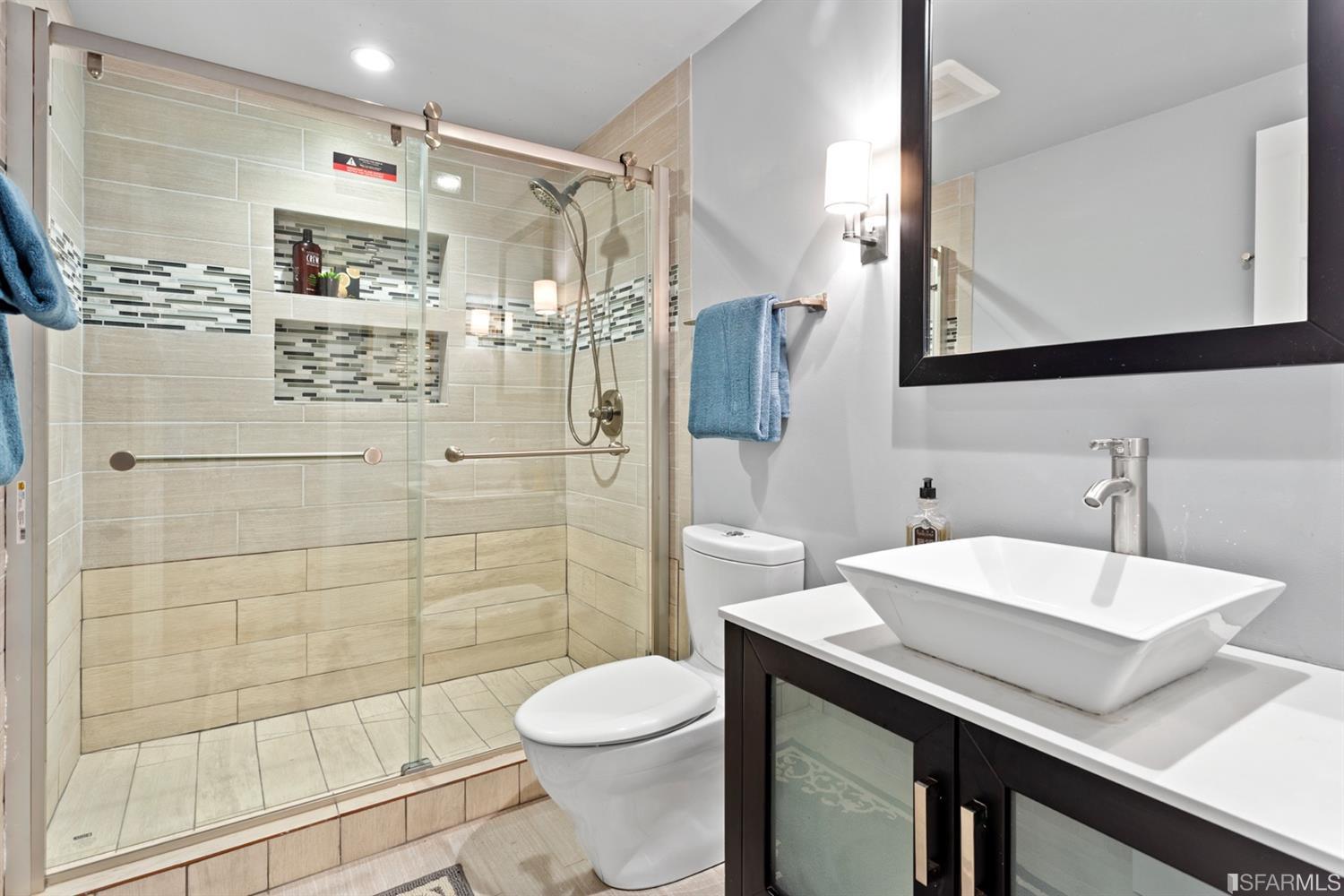 26 Eagle Street San Francisco, CA 94114 - Photo 31 of 56 a bathroom with a sink toilet a mirror and shower