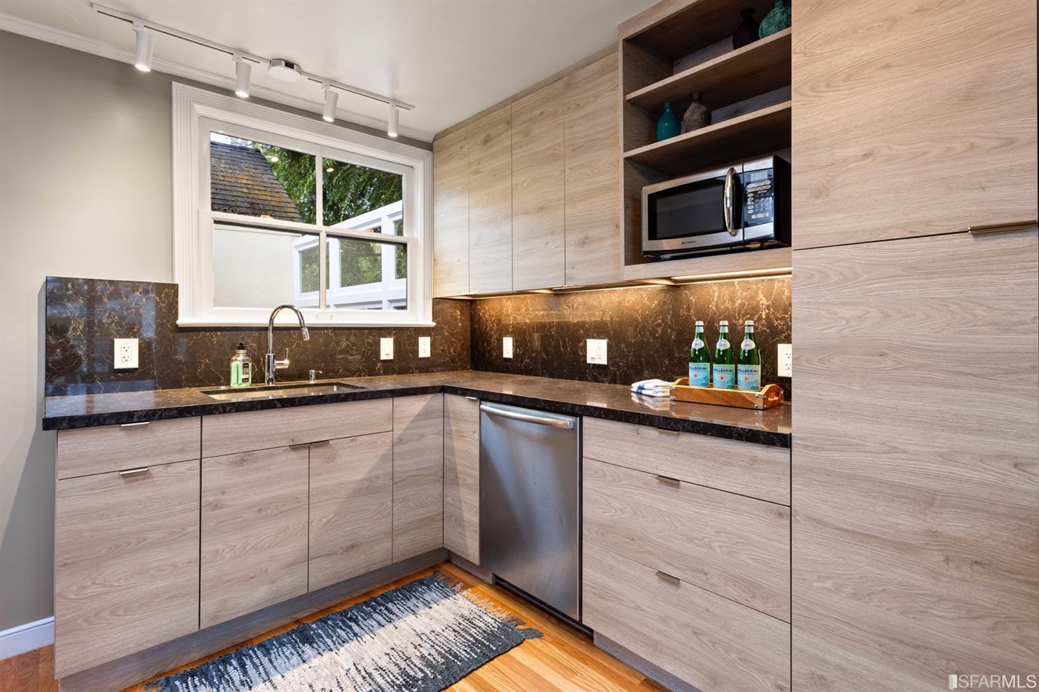 26 Eagle Street San Francisco, CA 94114 - Photo 8 of 56 a kitchen with stainless steel appliances granite countertop a sink a stove and cabinets