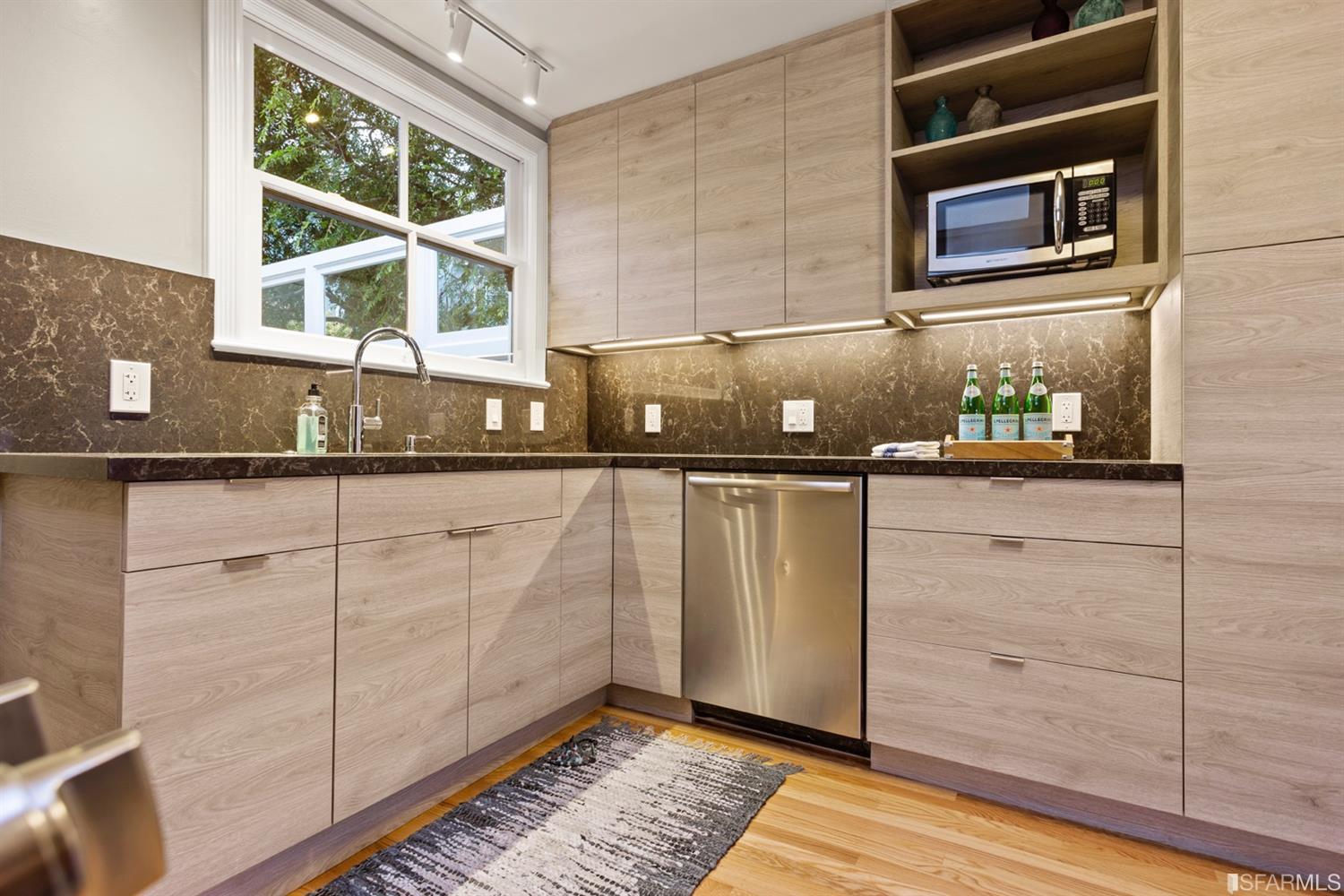 26 Eagle Street San Francisco, CA 94114 - Photo 9 of 56 a kitchen with granite countertop a sink and a microwave