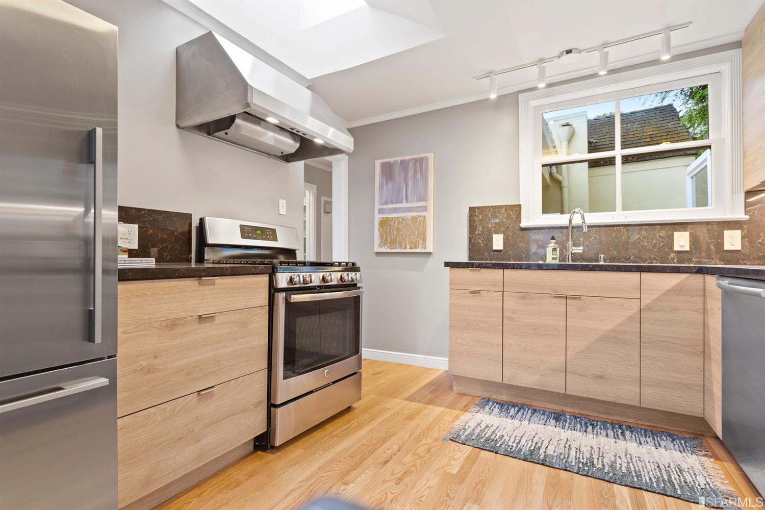 26 Eagle Street San Francisco, CA 94114 - Photo 10 of 56 a kitchen with granite countertop a stove a sink and a refrigerator