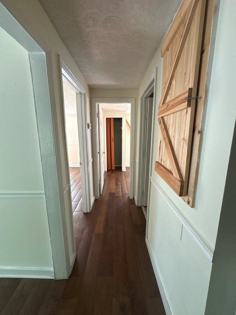 2910 Beech Street Columbus, GA 31909 - Photo 9 of 24 a view of a hallway with wooden floor and stairs