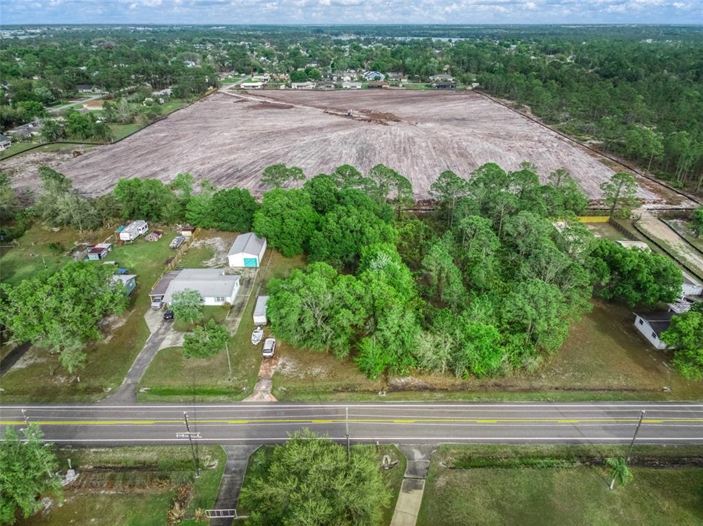 4814 Lakewood Road Sebring, FL 33875 - Photo 1 of 17 an aerial view of a yard with plants and large trees