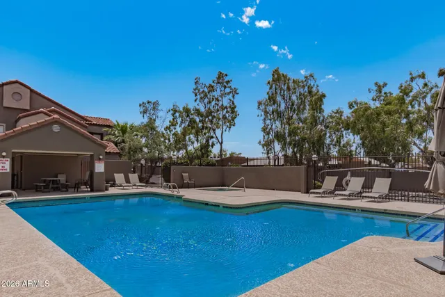 a swimming pool with outdoor seating and yard