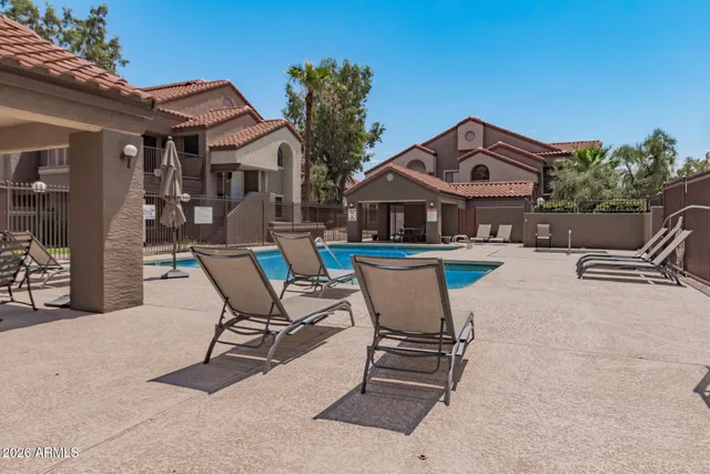 a view of a patio with table and chairs and potted plants