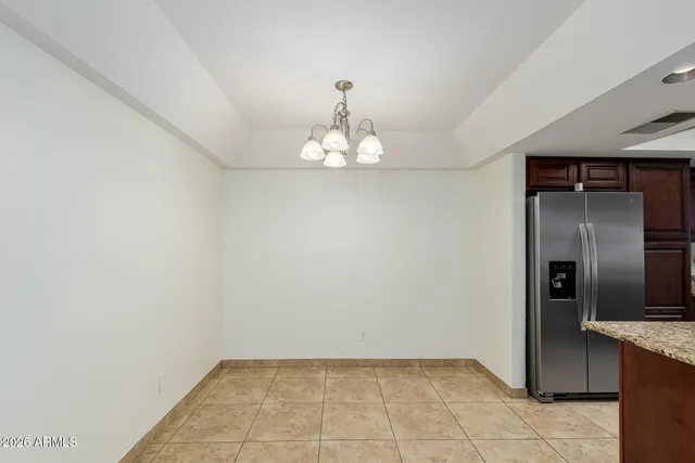 a view of a kitchen with a sink and a refrigerator