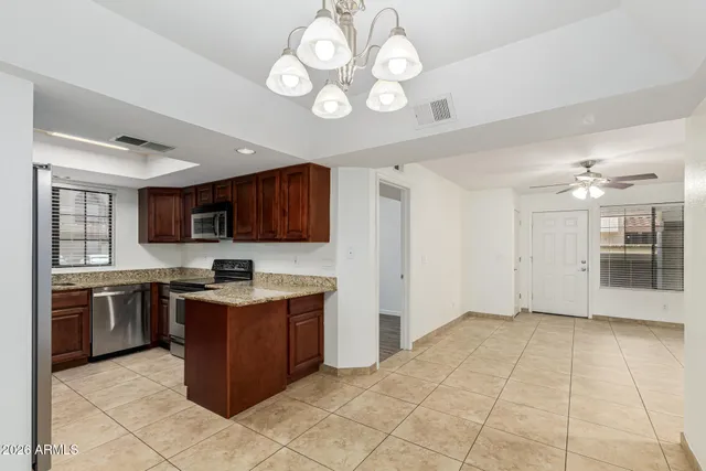 a view of a kitchen with a sink cabinets and stainless steel appliances