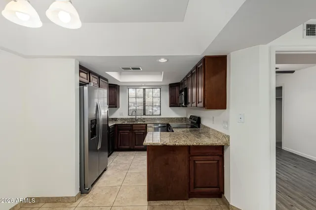 a kitchen with a refrigerator and a sink