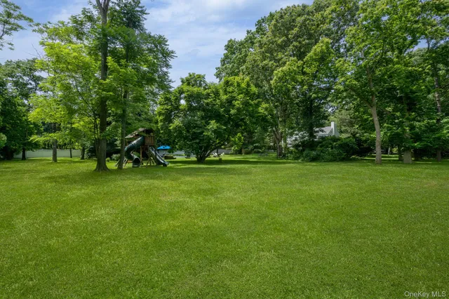 a view of a house with a yard and sitting area
