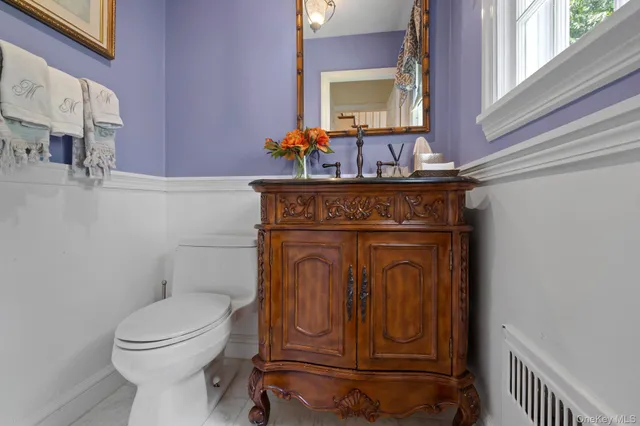 a bathroom with a toilet a sink and mirror