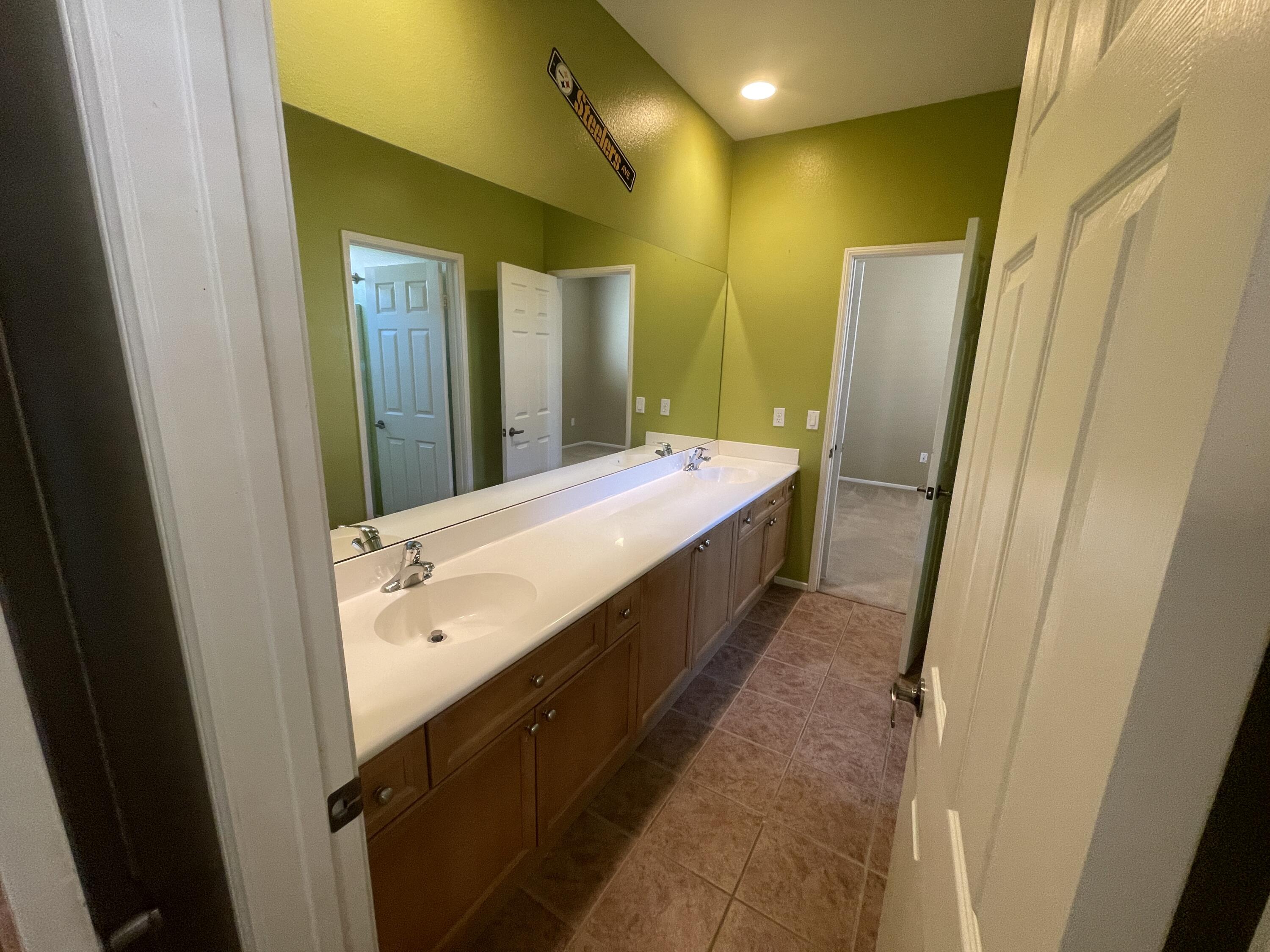 82838 Vincent Drive Indio, CA 92203 - Photo 15 of 37 a spacious bathroom with a double vanity sink and mirror