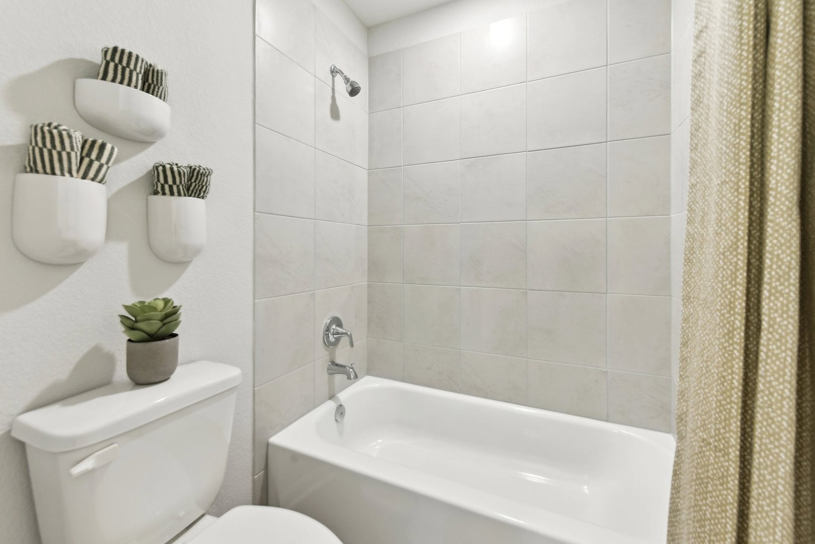253 Firefox Way Jarrell, TX 76537 - Photo 14 of 17 A well-appointed bath with tiled shower walls and a crisp white tub for relaxation.