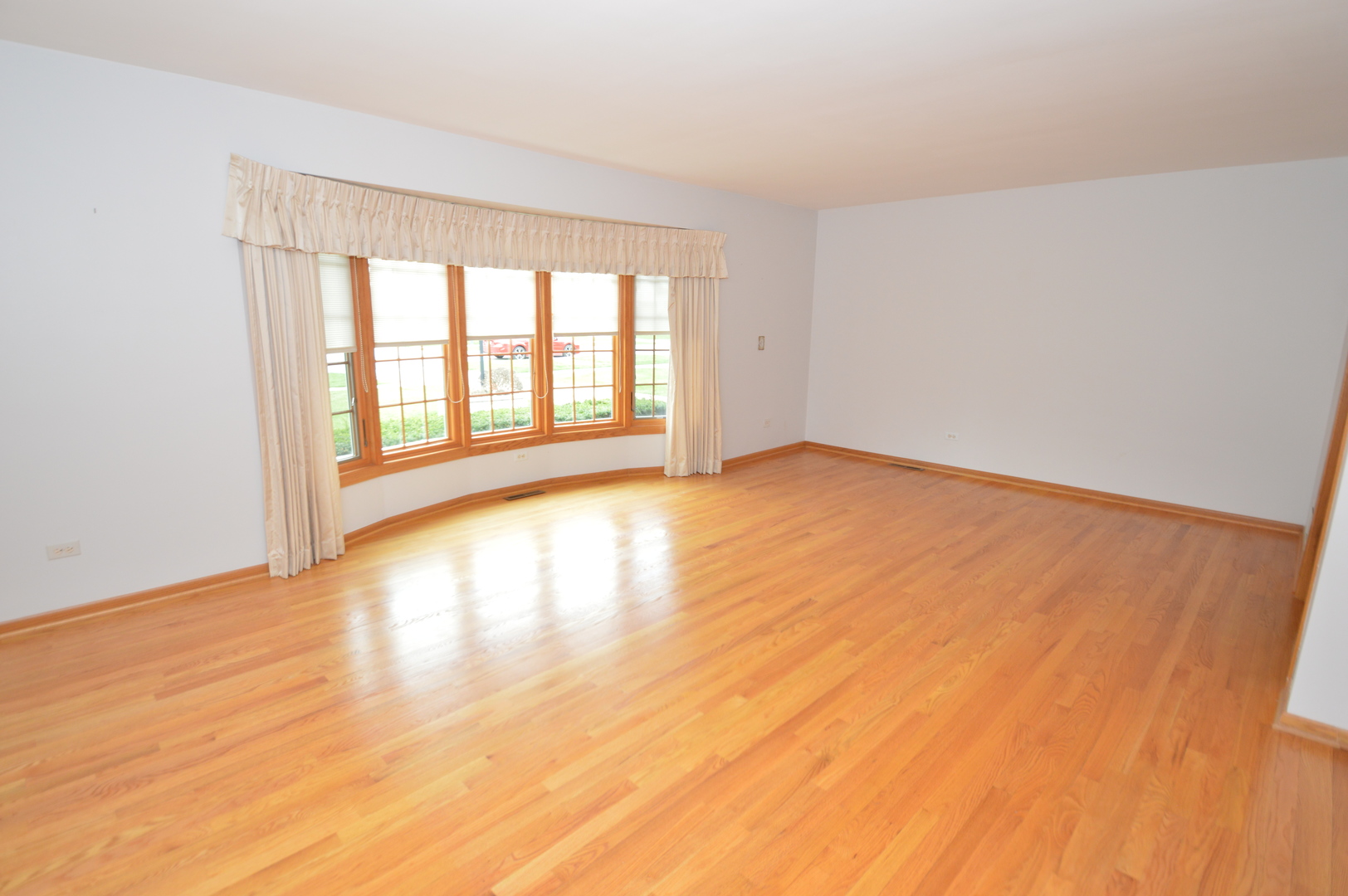 499 Selborne Road Riverside, IL 60546 - Photo 3 of 35 wooden floor in an empty room with a window