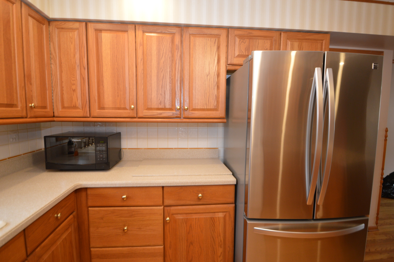 499 Selborne Road Riverside, IL 60546 - Photo 10 of 35 a kitchen with metallic refrigerator and cabinet