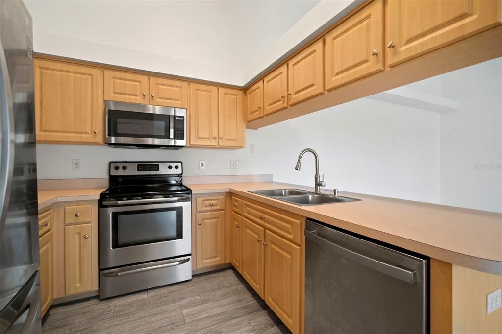 1013 Apollo Beach Boulevard, Unit 203 Apollo Beach, FL 33572 - Photo 16 of 26 a kitchen with sink a microwave and stove