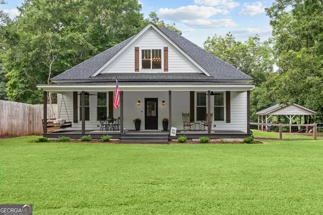 a front view of house with yard and green space