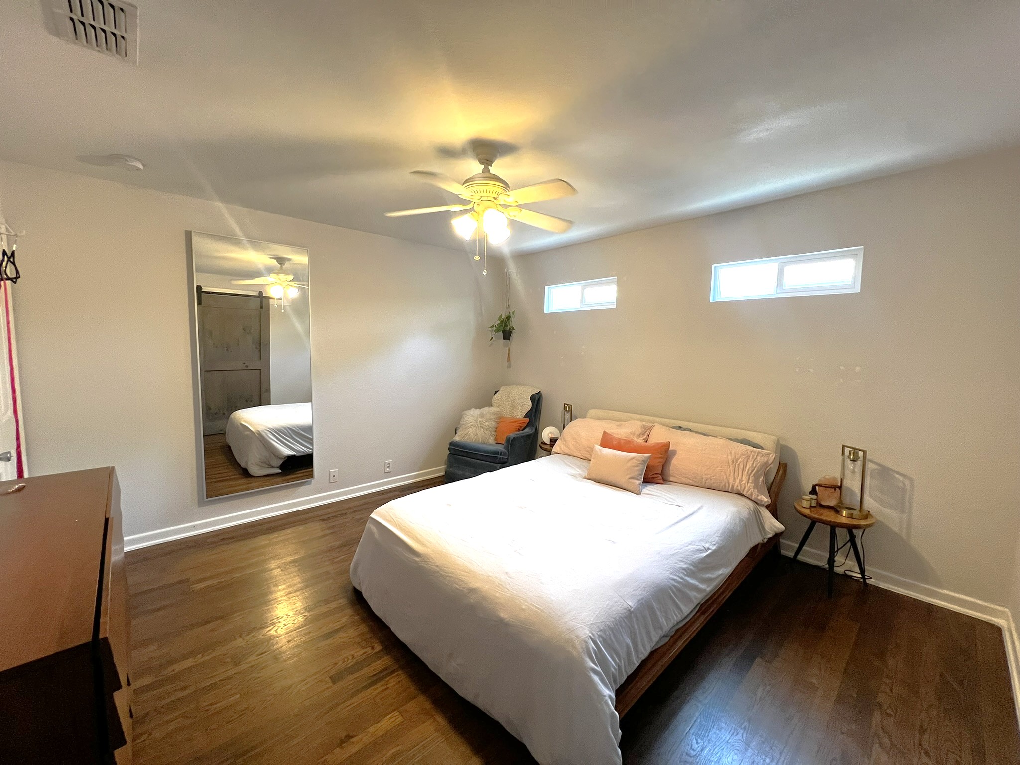 1311 Aggie Lane, Unit A Austin, TX 78757 - Photo 6 of 13 Primary Bedroom with wood finished floors, baseboards, and ceiling fan