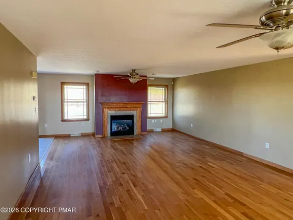 a living room with furniture a rug and a fireplace