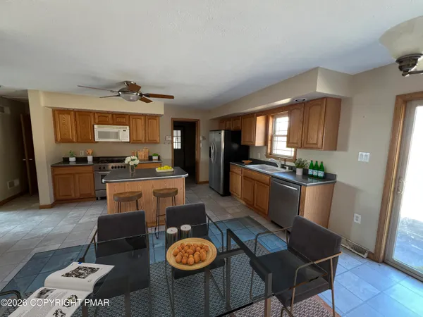 a kitchen with stainless steel appliances a stove a sink and a refrigerator