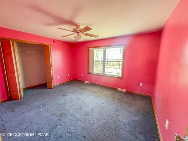 a bed room with a bed mirror and a window