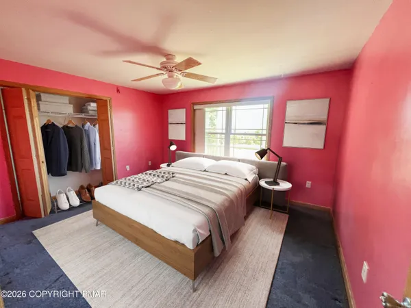 a view of a room with window and a ceiling fan