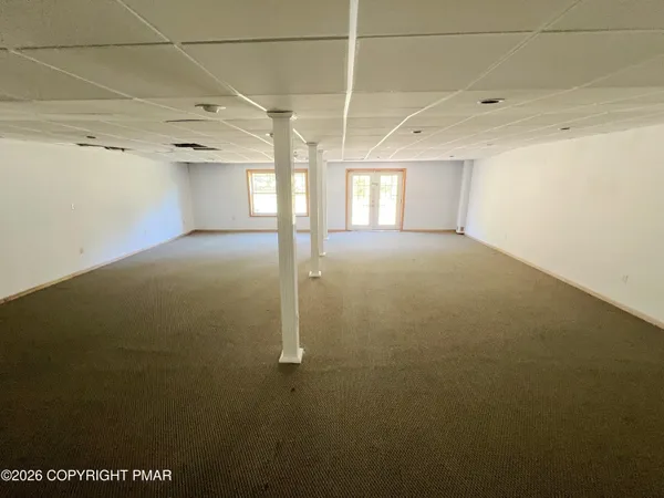 a view of a livingroom with an empty space and a window