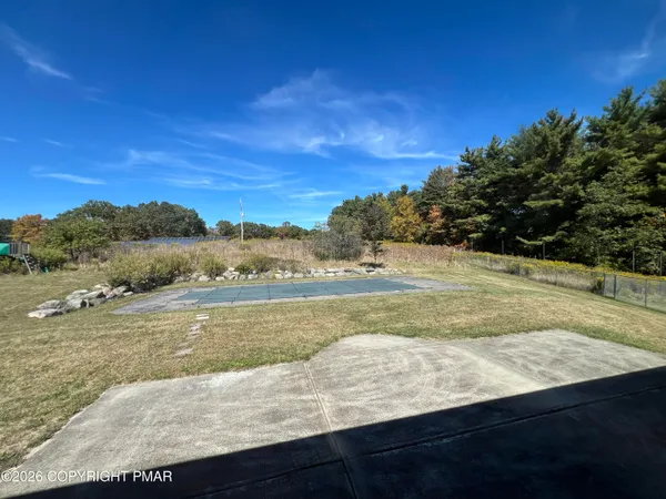 a view of empty room with wooden floor and fireplace