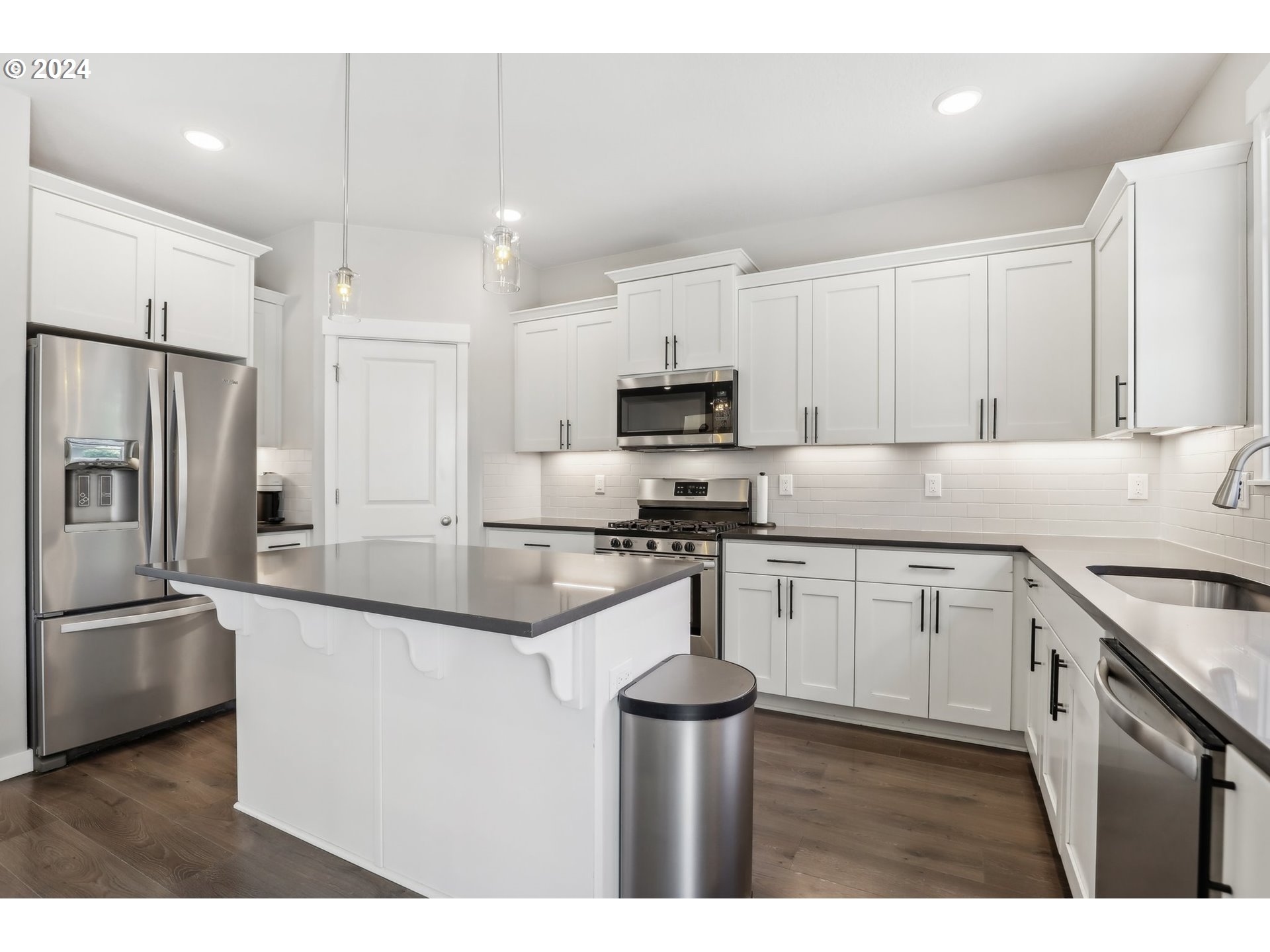 1817 Northeast 171st Street Ridgefield, WA 98642 - Photo 11 of 32 a kitchen with kitchen island a sink stainless steel appliances and cabinets
