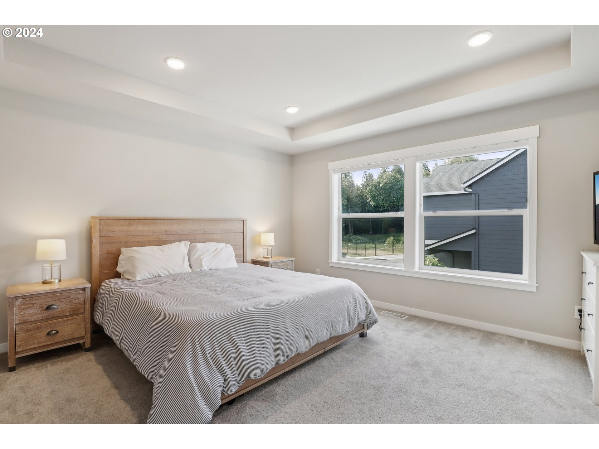 1817 Northeast 171st Street Ridgefield, WA 98642 - Photo 14 of 32 a bedroom with a large bed and a large window