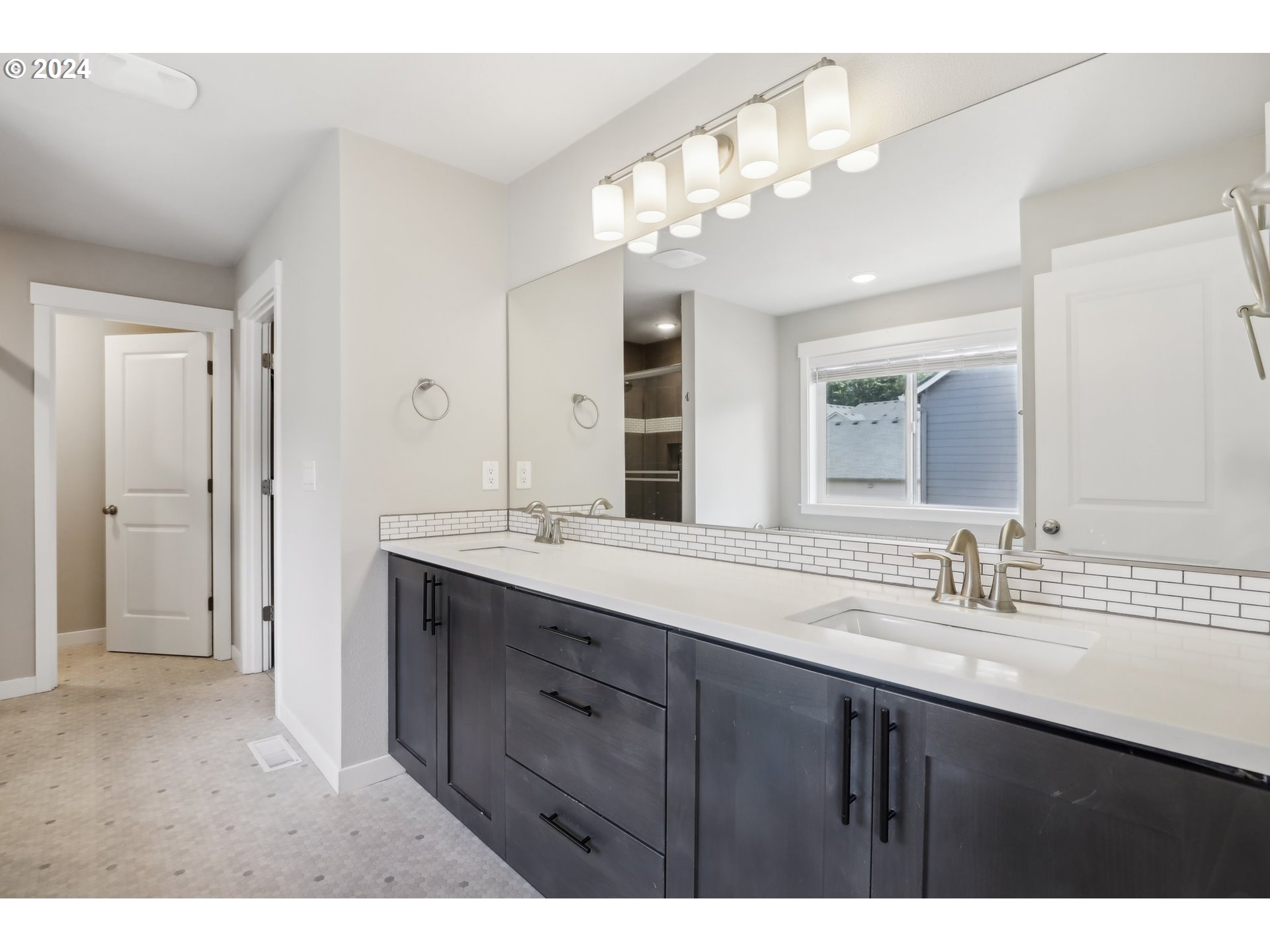 1817 Northeast 171st Street Ridgefield, WA 98642 - Photo 17 of 32 a bathroom with a sink double vanity and a mirror