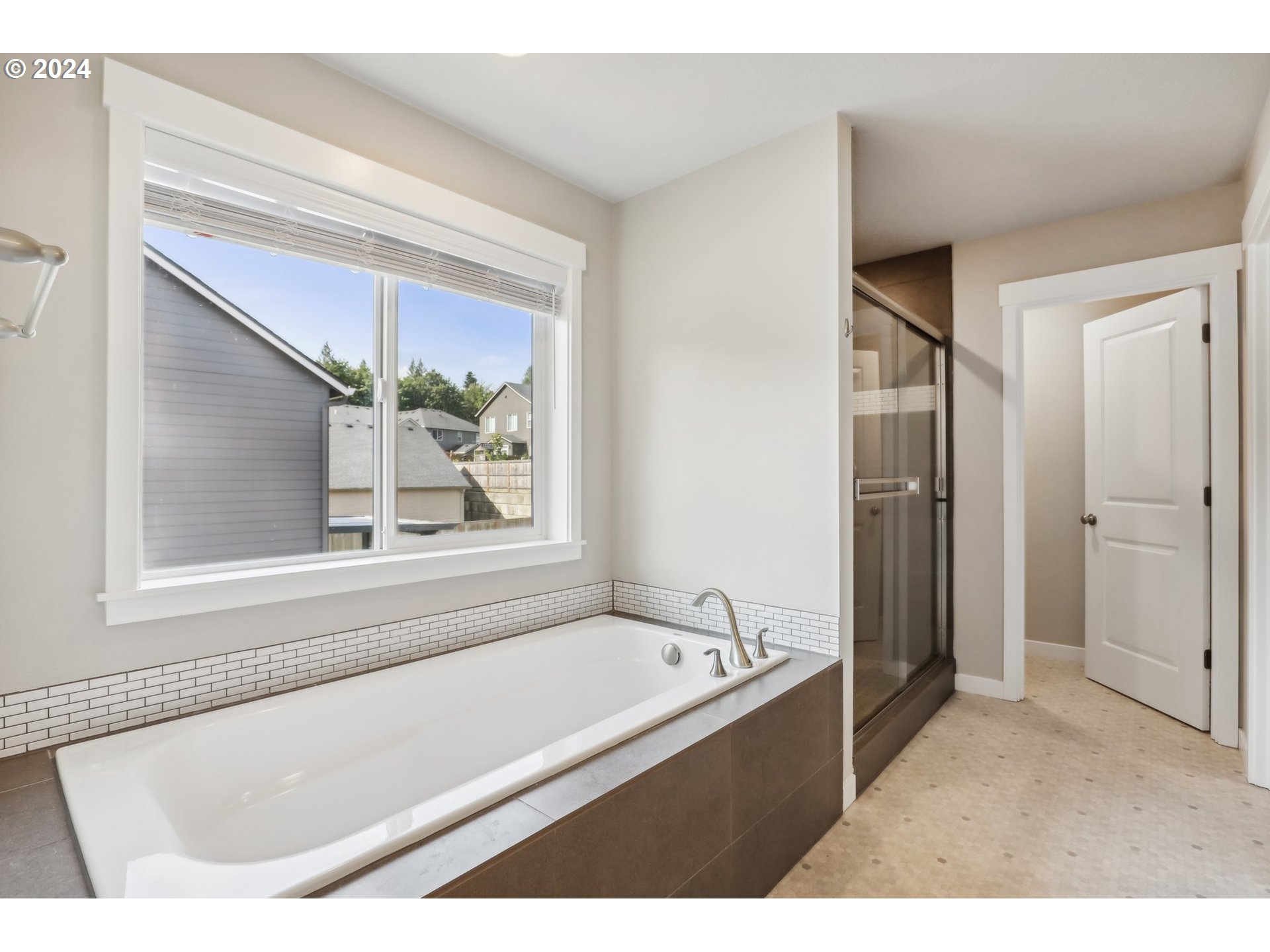 1817 Northeast 171st Street Ridgefield, WA 98642 - Photo 18 of 32 a bathroom with a bathtub and a window