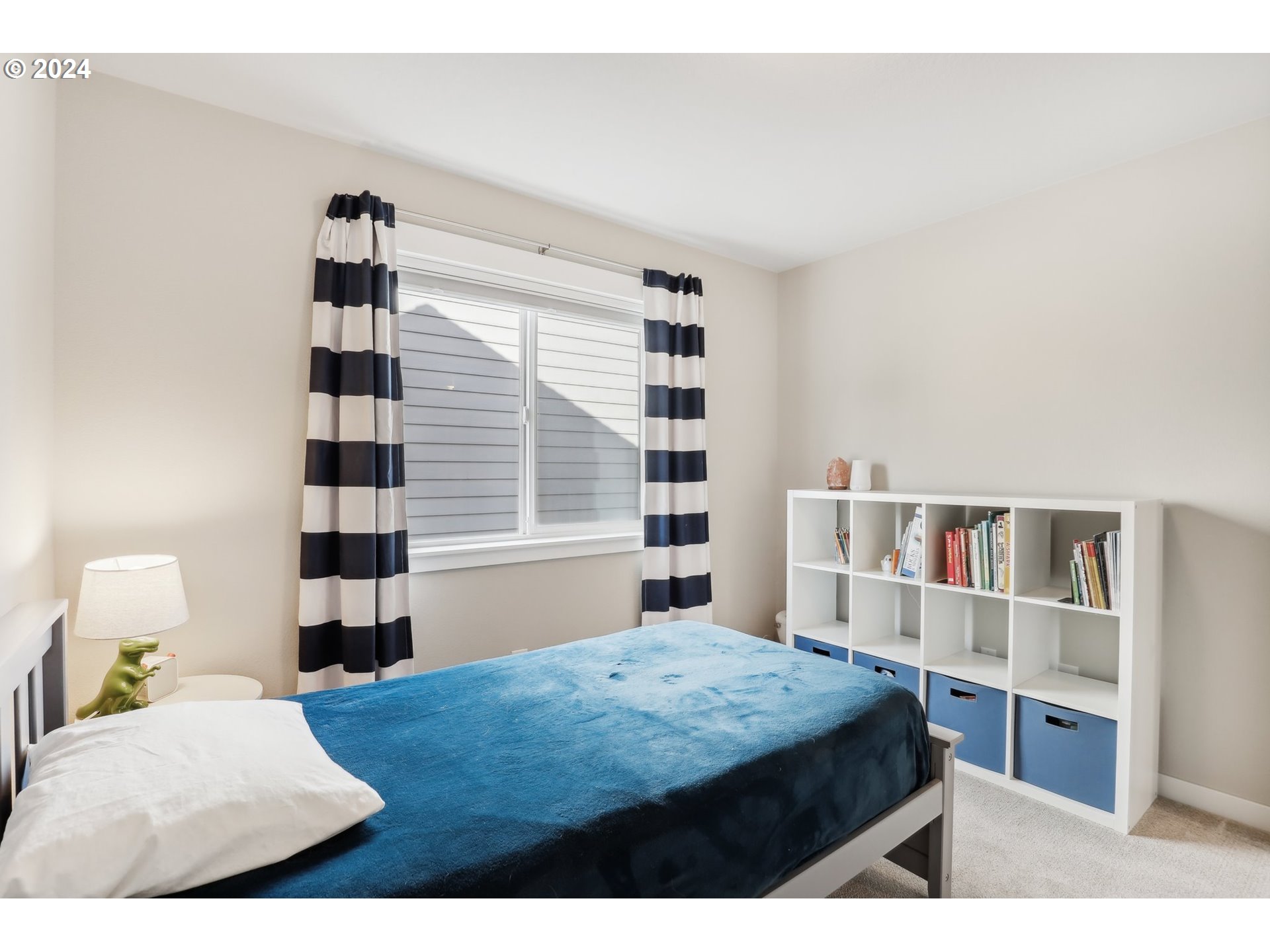 1817 Northeast 171st Street Ridgefield, WA 98642 - Photo 27 of 32 a bedroom with a bed and a book shelf