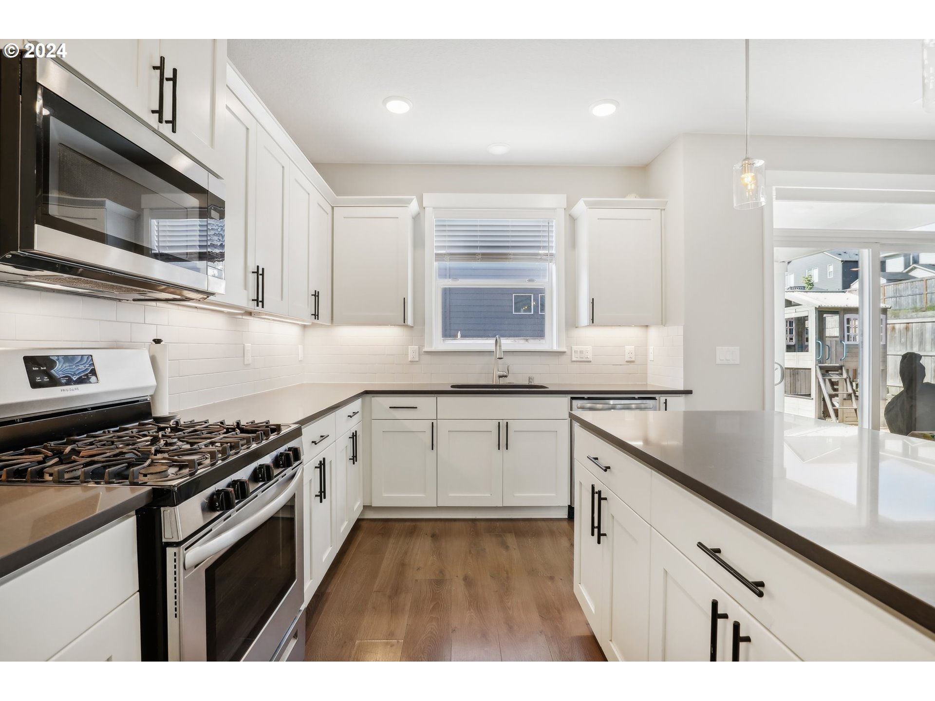 1817 Northeast 171st Street Ridgefield, WA 98642 - Photo 9 of 32 a kitchen with granite countertop cabinets stainless steel appliances and a sink