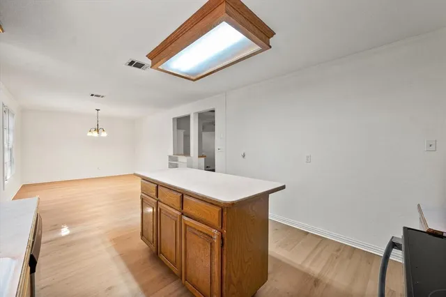 a kitchen with a stove and a wooden floor