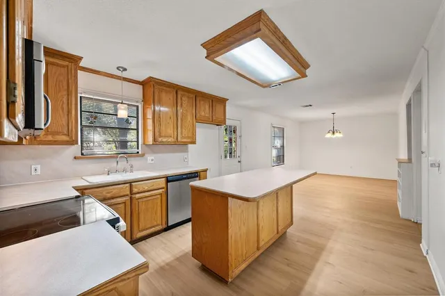 a kitchen with stainless steel appliances a sink stove and cabinets