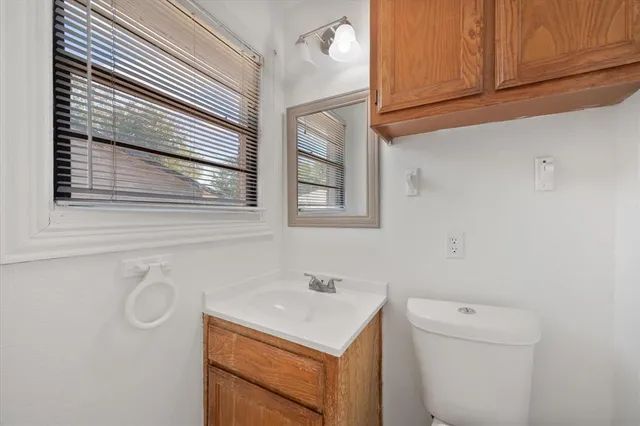 a bathroom with a sink a toilet and a mirror