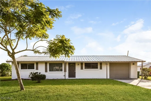 front view of a house with a yard