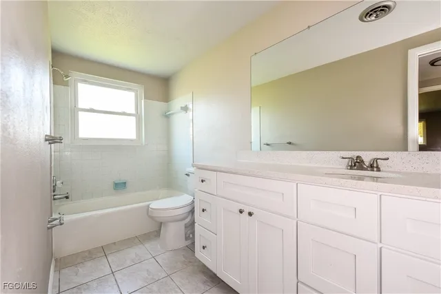 a bathroom with a double vanity sink toilet and shower
