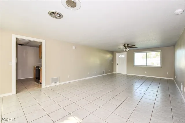 an empty room with windows and entrance