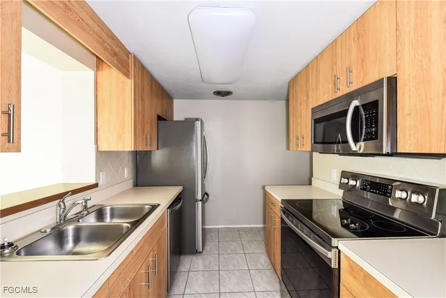 a kitchen that has a sink and a stove