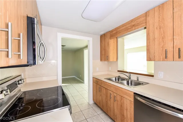 a kitchen with a sink and a stove top oven