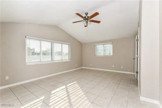 a view of a livingroom with a window and a ceiling fan