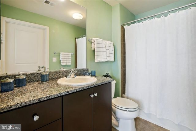 a view of a patio with chairs and table under an umbrella