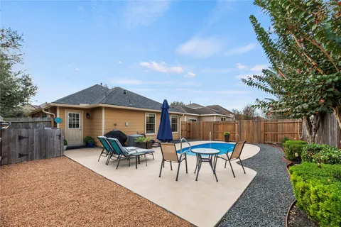 a view of a patio with couches chairs potted plants and a palm tree