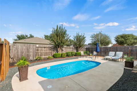 a view of a swimming pool with chairs