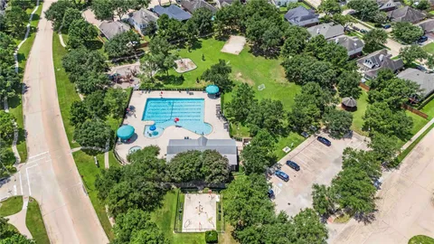 an aerial view of a house with a yard and garden
